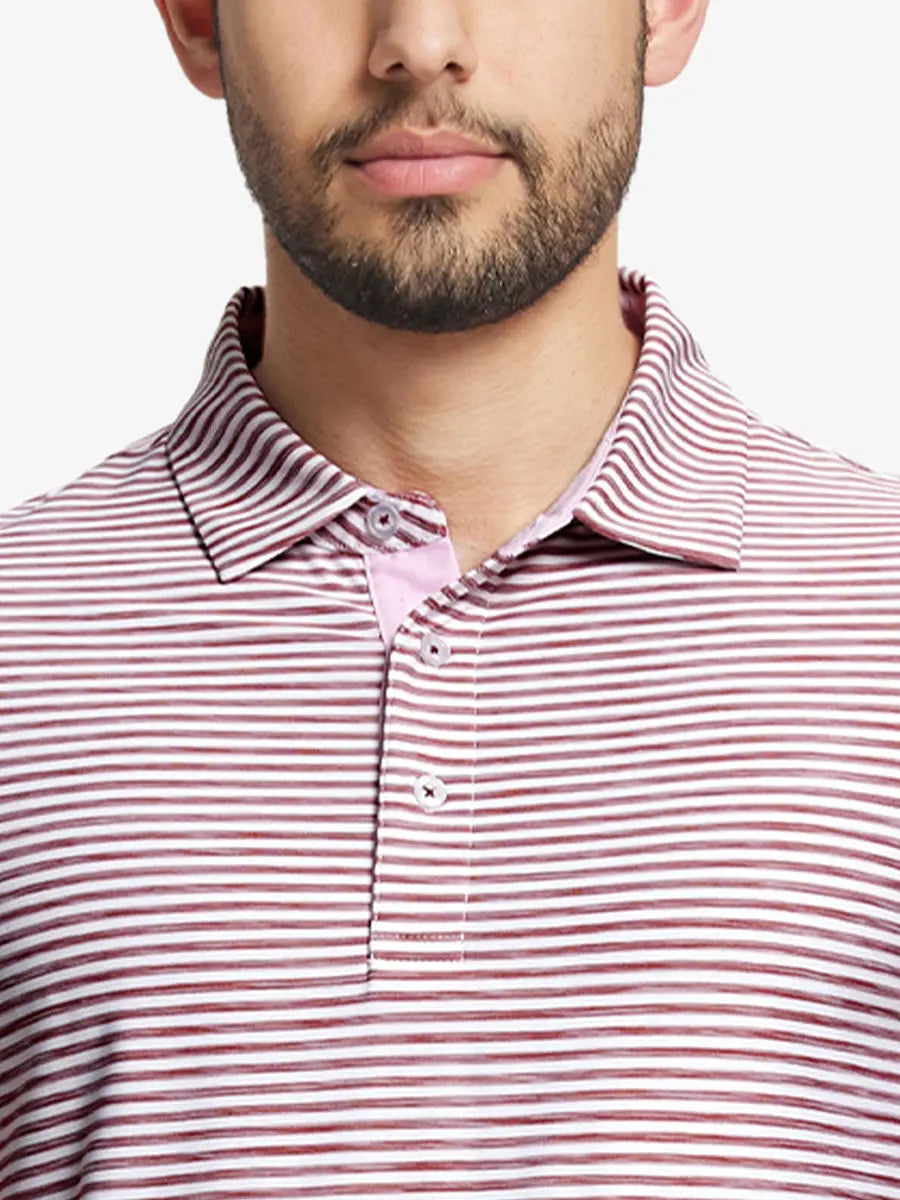 Close-up from nose to chest of BRICK WHITE polo featuring bold watercolor stripes in earthy tones