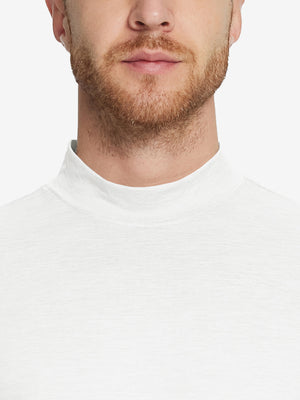 Close-up collar view from nose to chest, showing fine fabric texture of the White turtleneck.