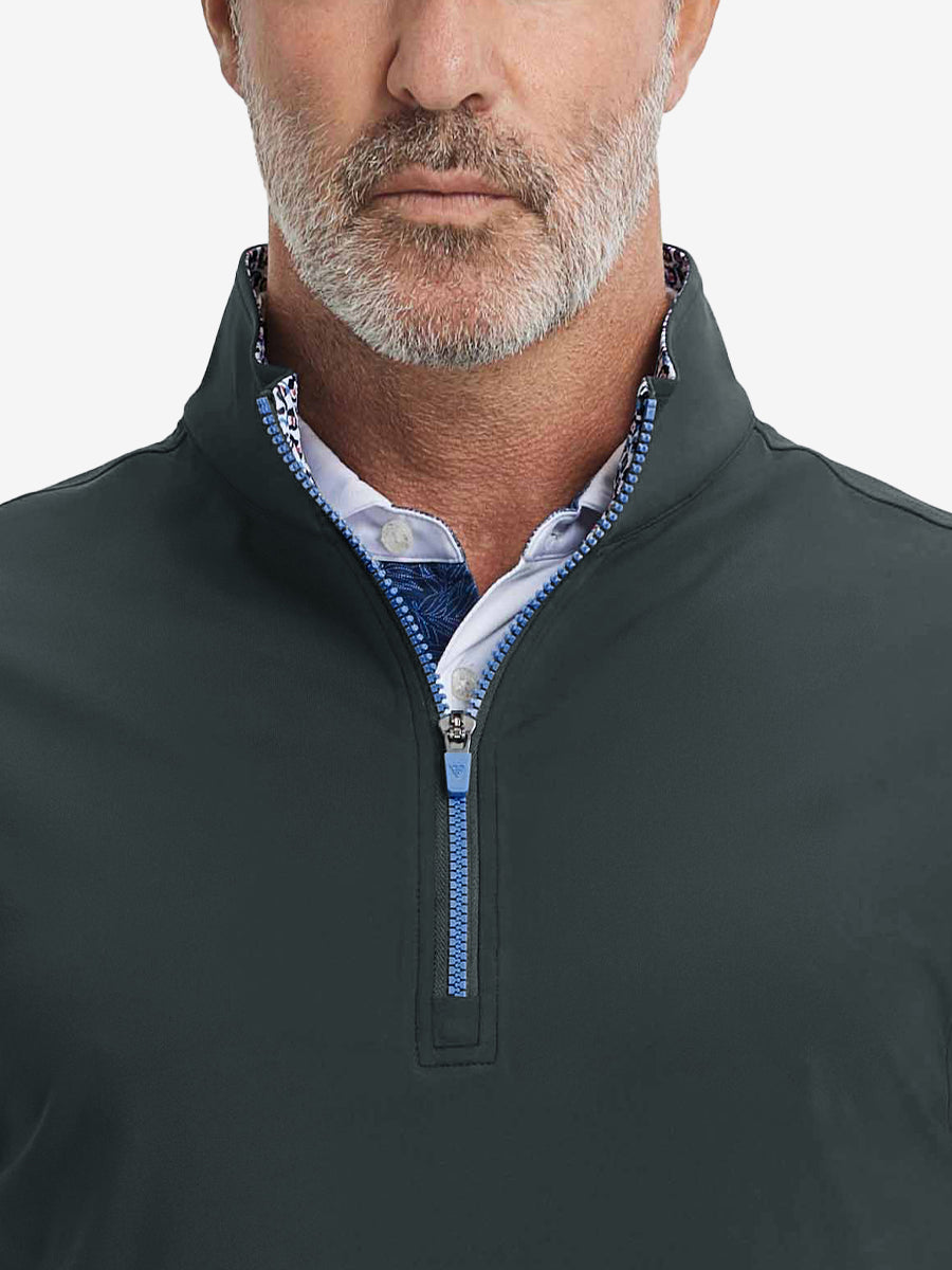 Close-up from nose to chest, showing collar detail and zipper of the dark grey golf vest.