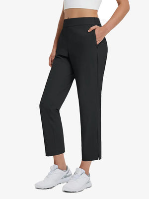 Front lower-body view of model with right hand in pocket wearing BLACK Women's 7/8 Ankle Golf Track Pants.
