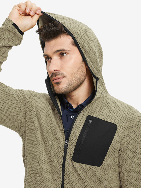 Model wearing hood and pulling it slightly, dressed in full zip fleece hoodied jacket in desert yellow.