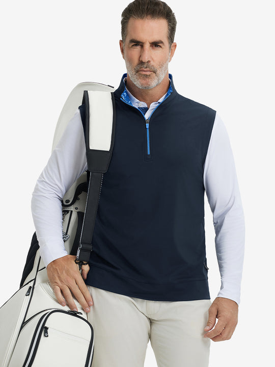 Model carrying golf bag, styled in navy print collar quarter zip golf vest, relaxed sporty fit.