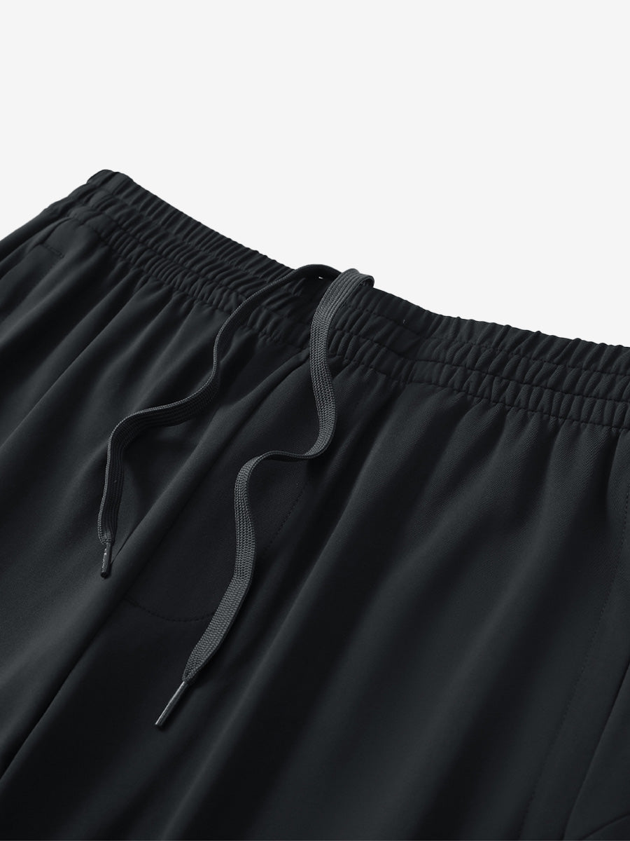 Angled view of lightweight women's stretchy joggers sweatpants waistband displayed in black.