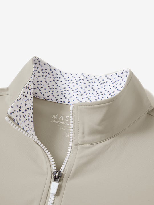 Zipper and inner pattern detail of the print collar quarter zip golf vest in khaki light, highlighting design.