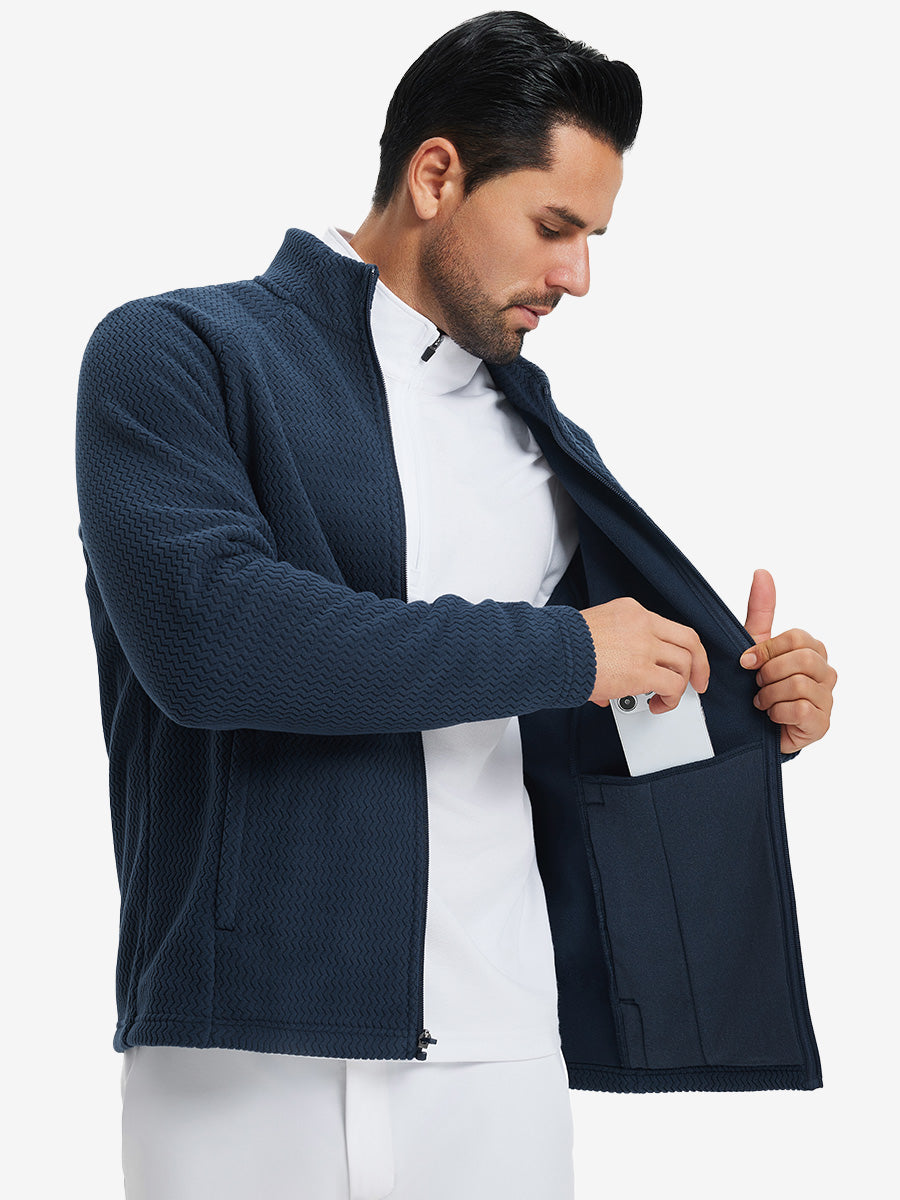 Model showing inner pocket of soft winter fleece jackets in navy, fitting an iPhone inside.