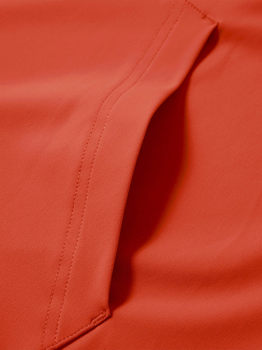Close-up of single pocket detail on youth long sleeve hoodied with kangaroo pocket in orange, showing stitching.