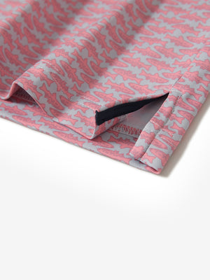 Hem slit detail of the pink small fish lightweight print long sleeve polo, showing fine stitching and finish.