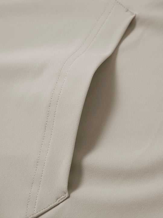 Close-up of single pocket detail on youth long sleeve hoodied with kangaroo pocket in khaki light, showing stitching.