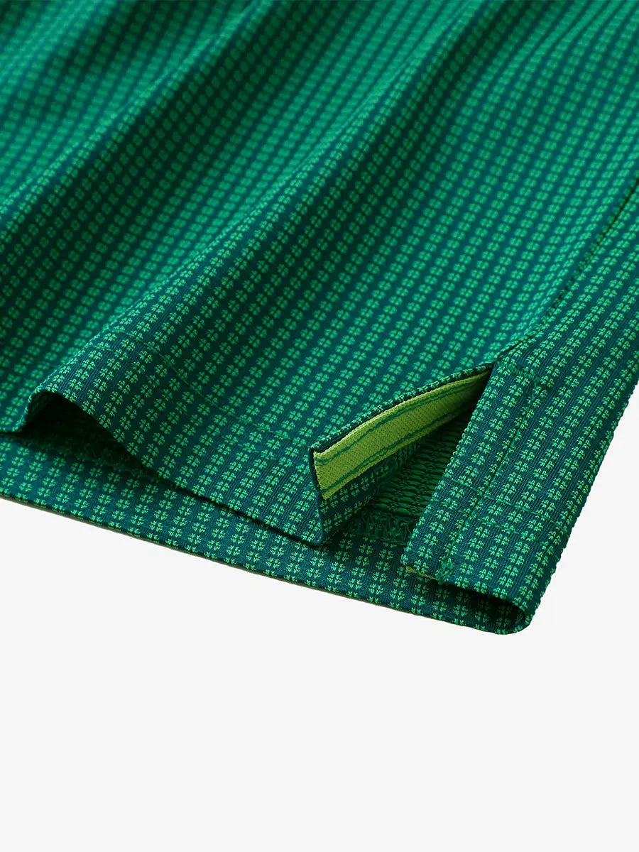 Close-up of hem slit detail on GREEN Elegant Performance Jacquard Polo