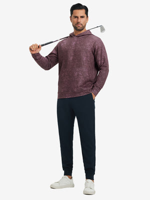 Full-body view of model in purple red exclusive print kangaroo hoodies holding a golf club outdoors.