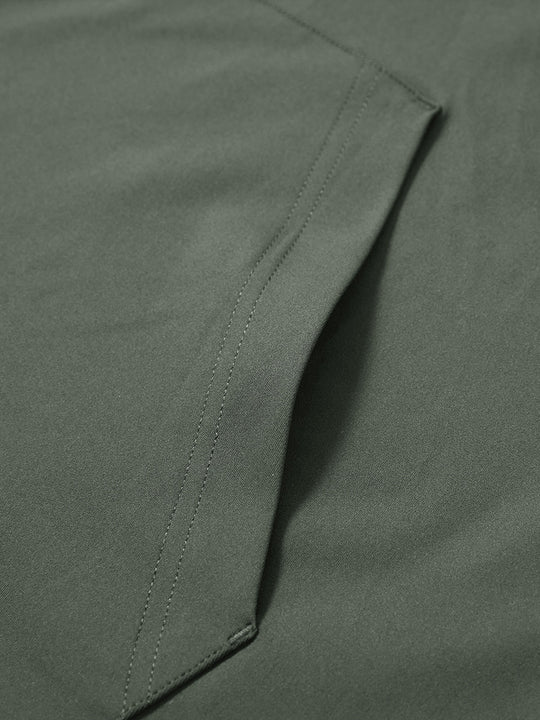 Close-up of single pocket detail on youth long sleeve hoodied with kangaroo pocket in olive green, showing stitching.