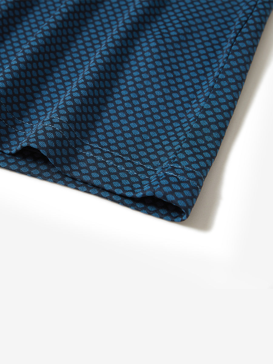 Hem detail of jacquard quarter zip pullover in navy/blue, focusing on stitching and side vent finish.