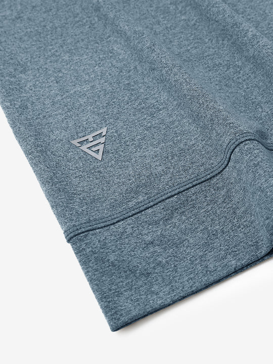 Hem detail of quarter zip melange pullover saxony blue melange with small maelreg logo.